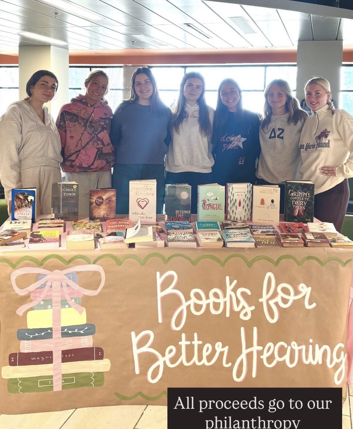 Hand-painted Books for Better Hearing banner at a sorority philanthropy event
