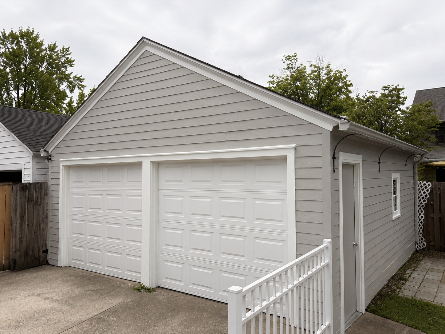 Detached garage after painting — clean gray repaint on wood siding, Grand Rapids MI