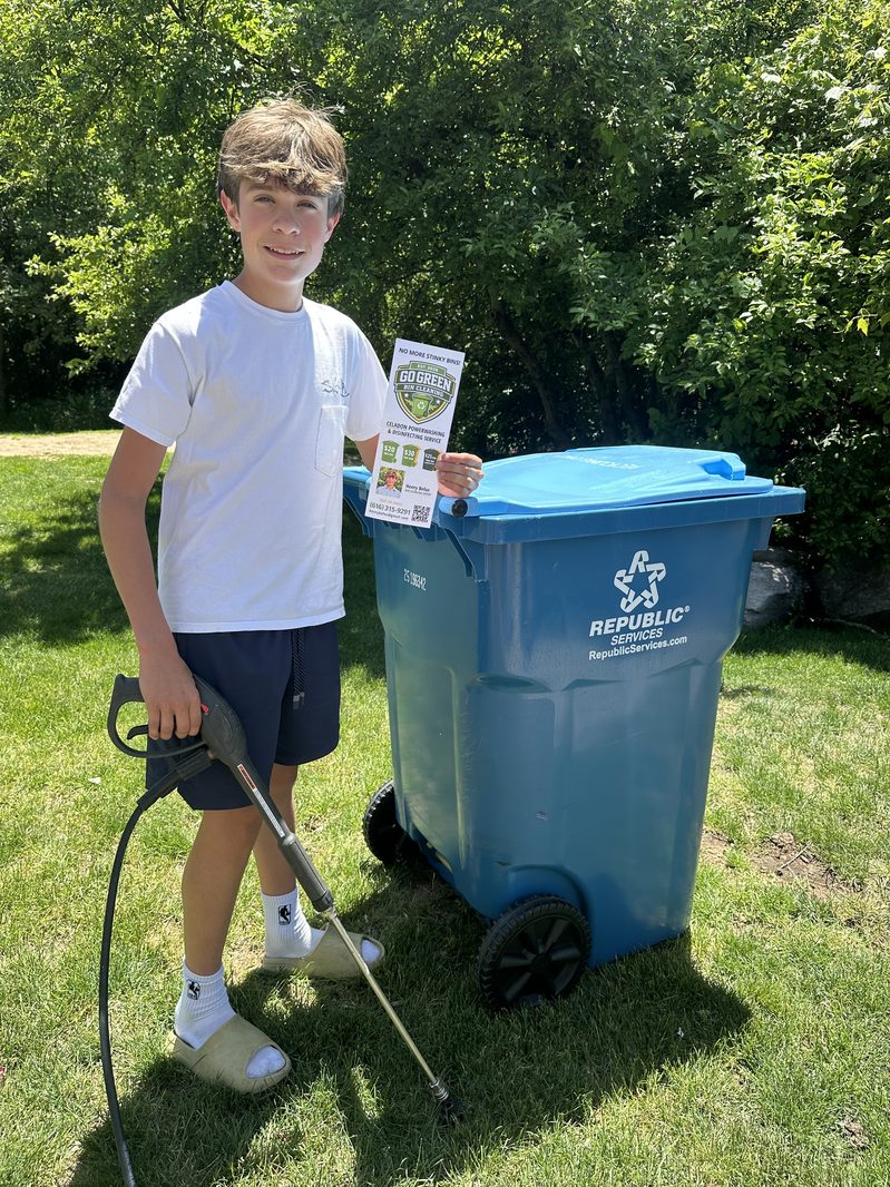Henry Befus, age 14, power washing a Republic Services bin — Go Green Painters power washing service, Grand Rapids MI